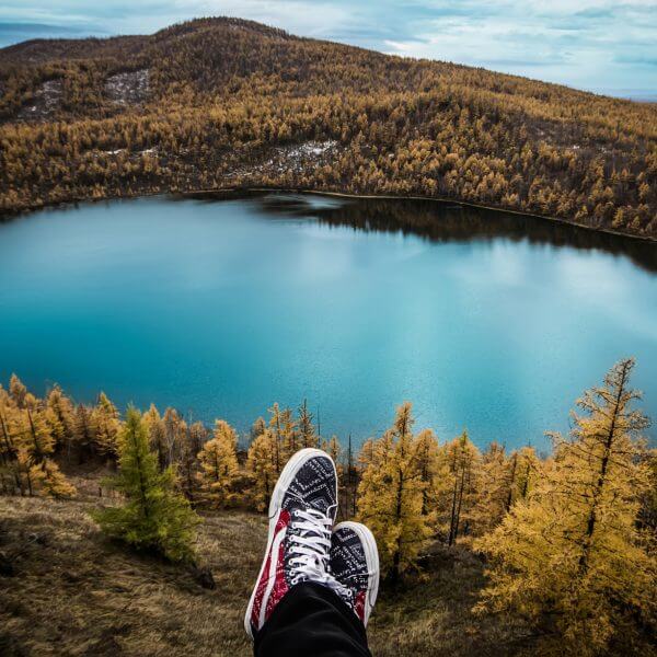 feet in front of a great view of a lake